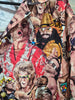 "Detail shot of WWE scrub top print showing Ultimate Warrior, Ric Flair, Macho Man Randy Savage, and button-front closure"