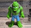 Front view with green scaly body, blue pants, and gray muzzle restraint details, killer croc, batman, dc